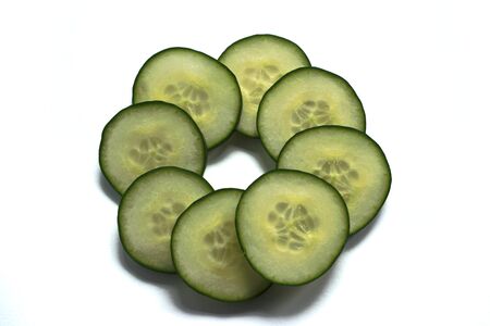 Closeup of cucumber slices on a white backgroundの写真素材
