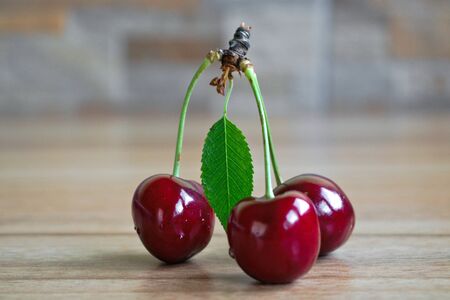 Closeup of cherries on a wooden tableの写真素材