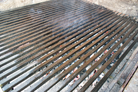 Closeup of coals burning under a grillの写真素材