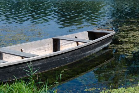 Old wooden boat on a riverの写真素材