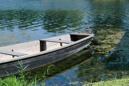 Old wooden boat on a riverの写真素材