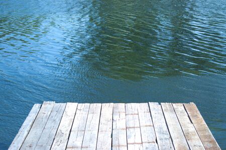 Old wooden dock over a riverの写真素材
