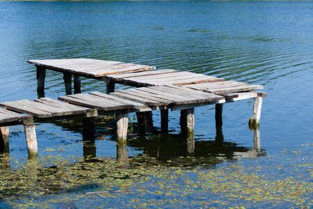 Old wooden dock over a riverの写真素材