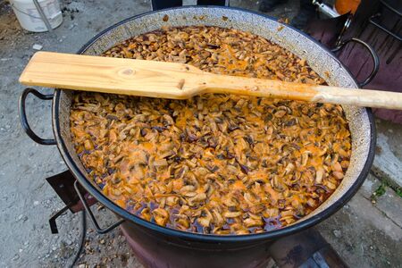 Mushroom stew cooking in a cauldronの写真素材