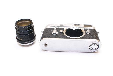 Old vintage rangefinder photo camera isolated over white background