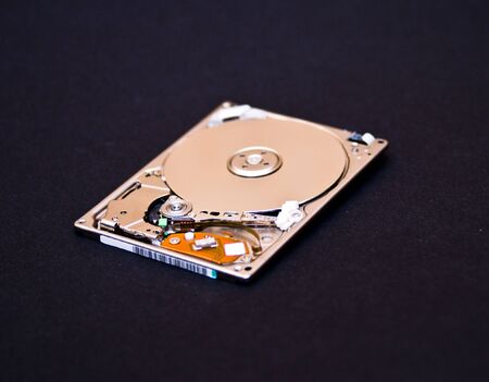 Hard disk drive isolated on black backgroundの写真素材