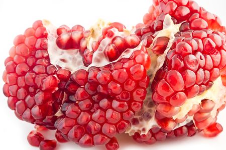 Ripe pomegranate seeds isolated on whiteの写真素材