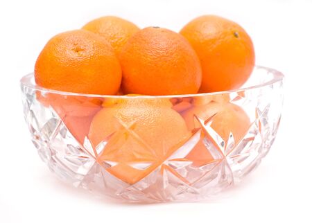 Tangerines in a bowl isolated on whiteの写真素材