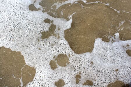Foam over Sandの写真素材