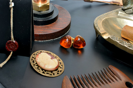 A pair of amber earrings lying on black backgroundの写真素材