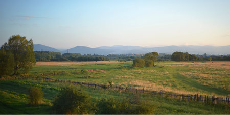 Wonderful panorama of the rural fields, mountains and skyの写真素材