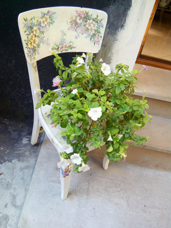 Bouquet of flowers stands on an old vintage chairの写真素材
