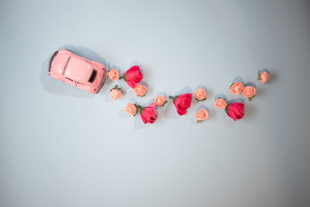 Pink retro car with a trace of flowersの写真素材