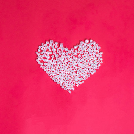 a pearl heart on a red background, a creative concept for Valentineâs Day and Motherâs Dayの写真素材