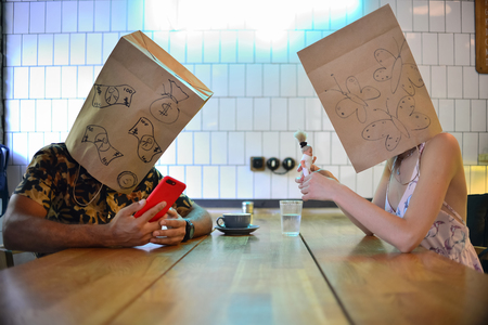 Guy with a girl with packages on his head. Modern Relationships.の写真素材