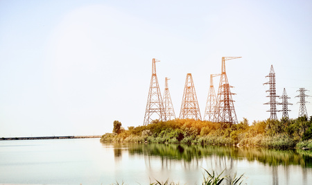 High voltage poles outside Lake. Blue river