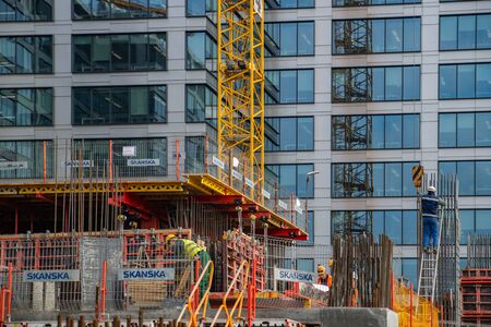 Worker waling beside scaffolding at top of building. February 18, 2019. Warsaw, Poland.のeditorial素材