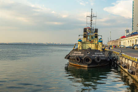 Odessa, Ukraine. August 05, 2018 Tug Pugachev is moored to the pier at the Odessa Maritime Station.Sea tugboat mooring in port at sunrise.のeditorial素材
