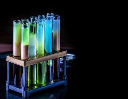 Cocktails in test tubes - creative alcohol bar drinks. Raibow liqhuids in tubes