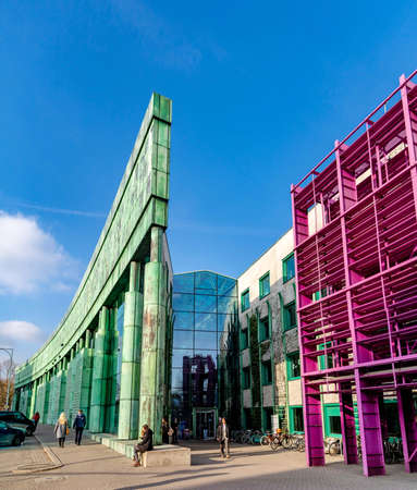February 18, 2019. Warsaw, Poland. University Library. The decorations on the facade of the university library building. Exterior green color facade of architecture with blue sky background.のeditorial素材