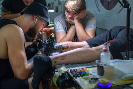 Odessa, Ukraine. July 22, 2018. Tattoo festival in Odessa. Tattoo master makes a tattooのeditorial素材
