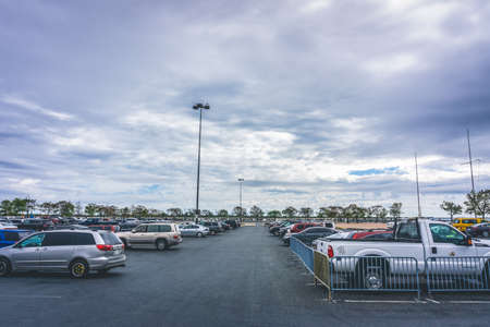 Queens, NY / USA - September 26 2020: Outdoor car parking in an asphalt lot with trees in the backgroundのeditorial素材