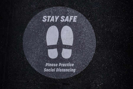 stay safe sign on a sidewalk. Covid-19 warning about keeping social distanceの写真素材