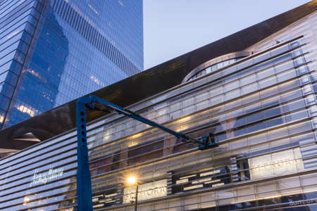 Professional windows cleaner washes windows of a building from a crane up highのeditorial素材