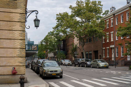 New York City, NY / USA - October 7 2020: Tree lined street of historic brownstone apartment buildings in West Village neighborhood in Manhattan, New York City. Cars parked along the streetのeditorial素材