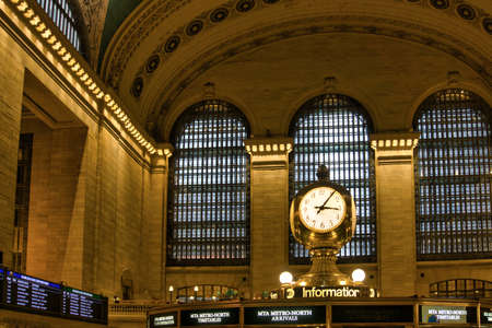 Grand Central Terminal with a big clock above information and pillars