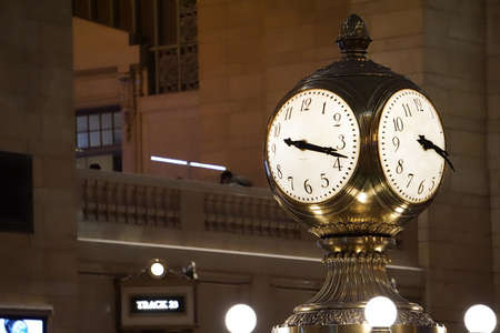 Grand Central Terminal with a big clock above information and pillars