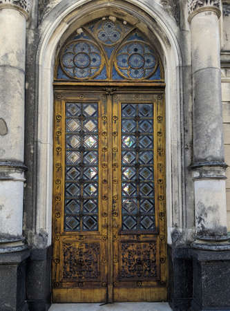 Buenos Aires, Argentina - February 15, 2019: Old tomb's rusty door in Recoleta Cemetery. Wooden...