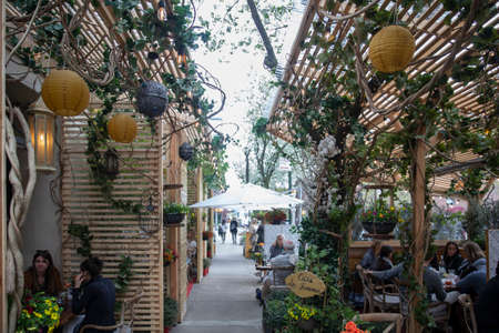 New York City - April 18 2021: Busy outdoor restaurant during covid outbreak. Restaurants started serving meals outdoors due to pandemic dining rules.のeditorial素材