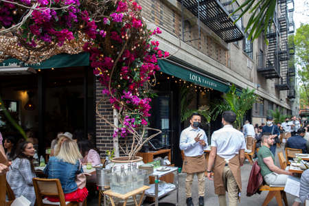 New York City - April 18 2021: Busy outdoor restaurant during covid outbreak. Restaurants started...