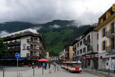 Chamonix-Mont-Blanc, Haute Savoie, France - August 25 2021: Tourists in the tram riding on a main street in Chamonix.のeditorial素材