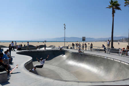 Los Angeles, CA - August 9 2021: Skate board park at Venice beach with young boy practicing outdoors