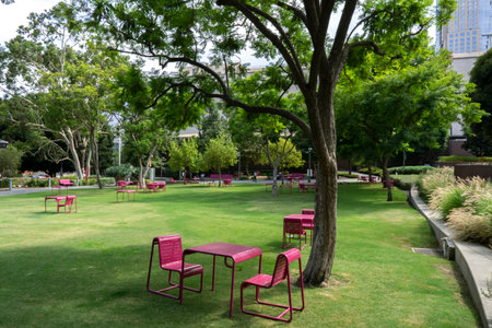 Seating area in a Park in Los Angeles. Empty red chairs and tables.の写真素材