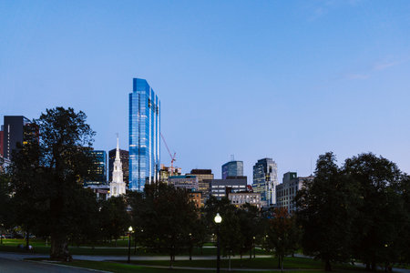 View of Boston Common public park with buildings in the background at dusk. Downtown Boston, Massachusettsの写真素材