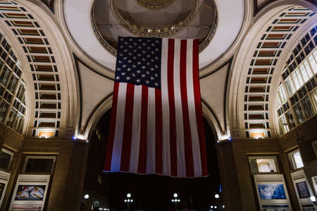 Boston, USA - October 22, 2021: American flag hanging at night from the doom ceiling in Boston Harbor, Massachusettsのeditorial素材