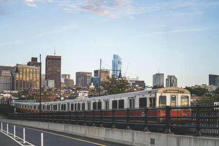 Boston red subway line on the Longfellow Bridge with scenic view of skyscrapers in the backgroundの写真素材