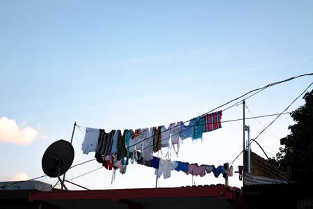 Rows of clothes hanging on ropes to air dry. Traditional way of doing laundryの写真素材