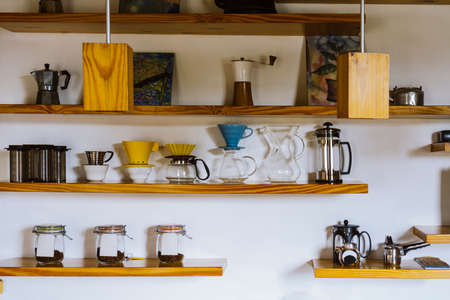 Wooden shelves with empty and clean appliances for making coffee. Coffee equipment on a wall shelfの写真素材