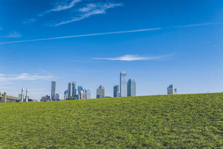 Long Island City in Queens, NY seen from Roosevelt Island. Lawn at front with tall modern buildings in the backgroundの写真素材