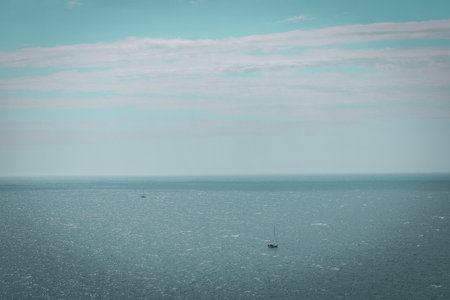 Sailing boat in a distance on open water. Mediterranean Sea with a blue skyの写真素材