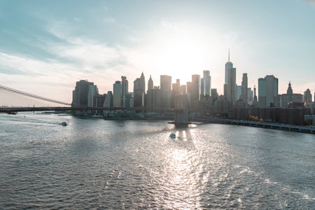 Sunset over East River and financial district Manhattan, NYC. View of Brooklyn Bridge and shade of itの写真素材