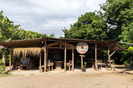 Wooden outdoor hat with shade and drinks for locals and tourists in Calibishie, Dominicaのeditorial素材