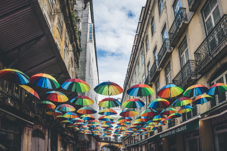 Lisbon, Portugal - March 8, 2023: Colorful umbrellas floating above on street in Lisbon, Portugalのeditorial素材