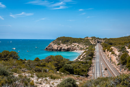 View of Sitges from distance. Train tracks. Landscape of coast, sea and mountainsの写真素材