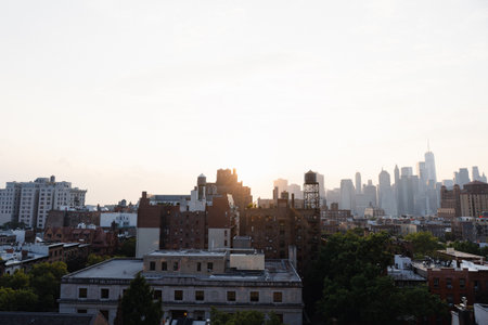 View of financial district Manhattan skyline and Brooklyn buildings at sunsetの写真素材