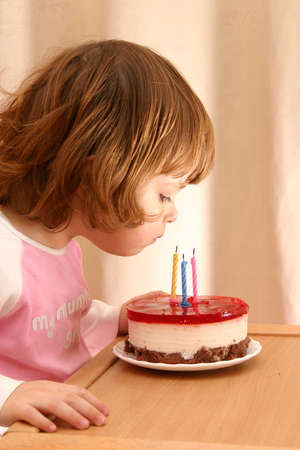 little girl and her birthday cake with candles
